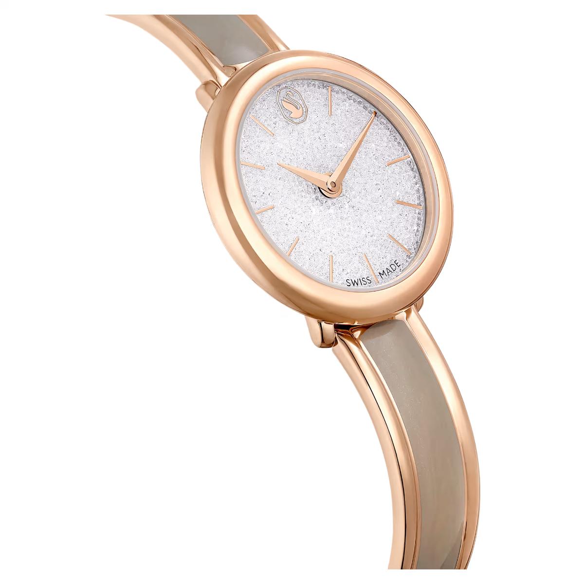 Rose gold watch with a white face on a white background
