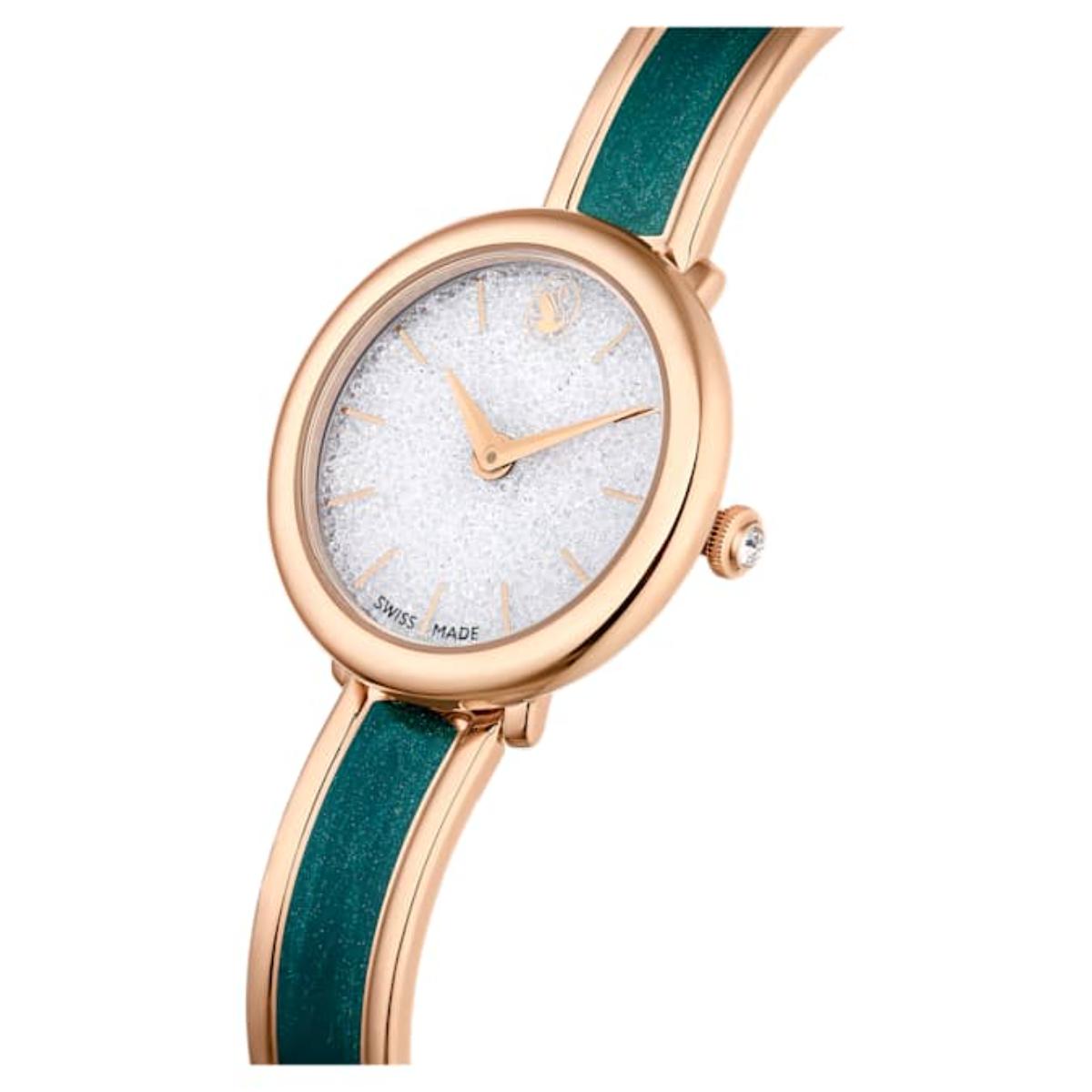 Wristwatch with rose gold case and green strap on a white background