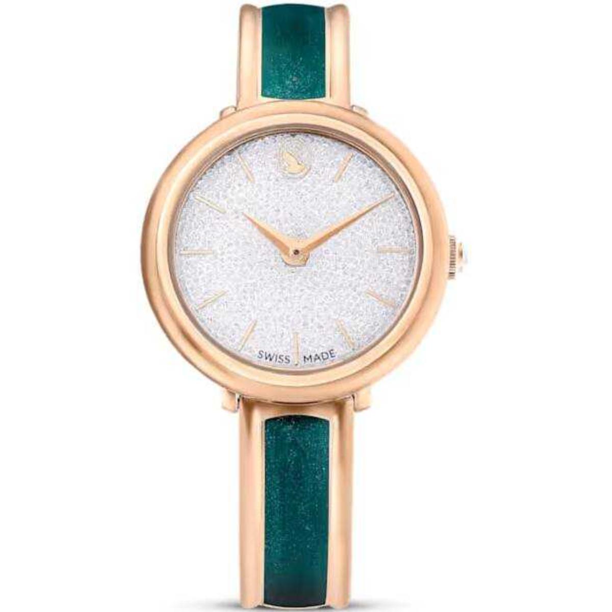 Watch with rose gold case and green strap on a white background