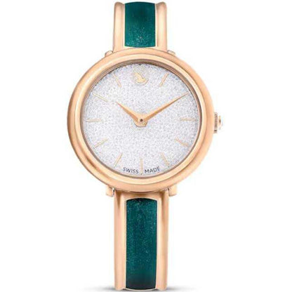 Watch with rose gold case and green strap on a white background
