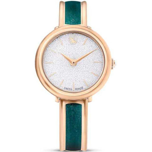 Watch with rose gold case and green strap on a white background