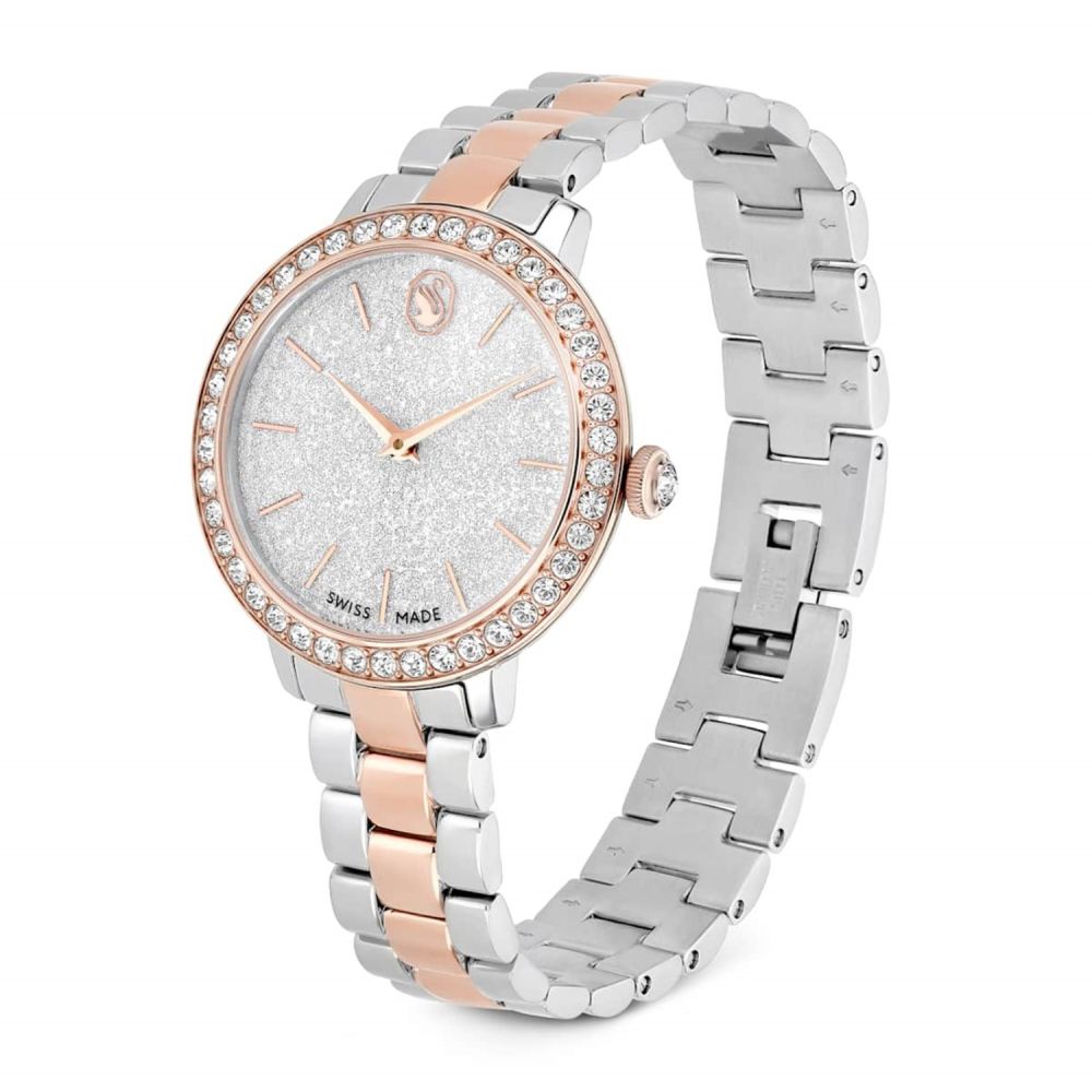 Silver and rose gold watch with gemstone-encrusted face on a white background