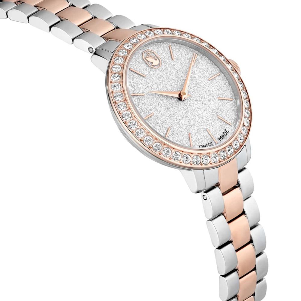 Silver and rose gold watch with a white face on a white background