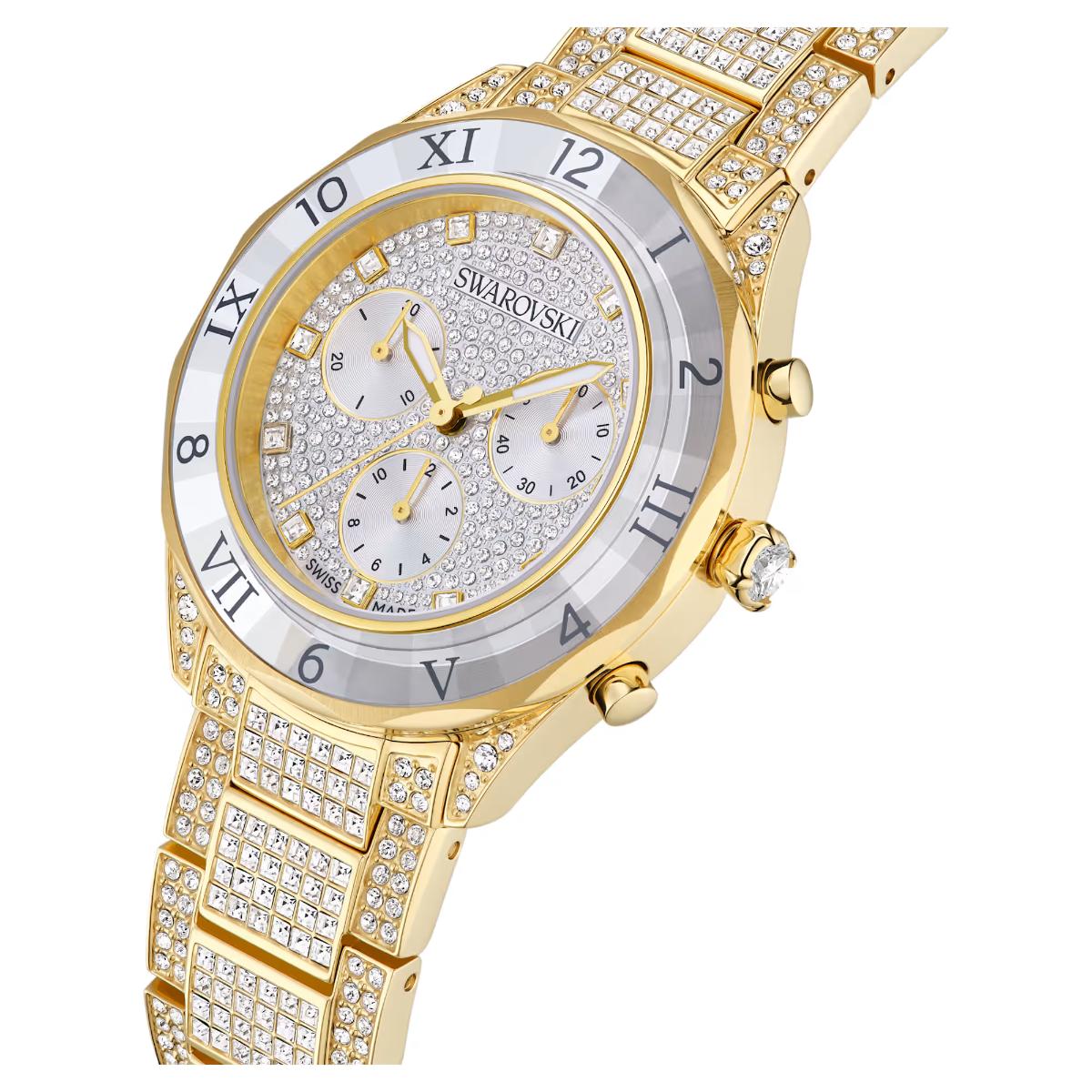 Gold Swarovski watch with diamond-studded face and band on a white background
