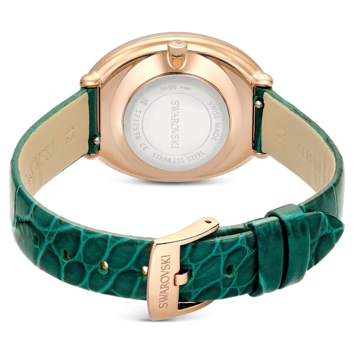 Swarovski watch with green strap and rose gold case on a white background