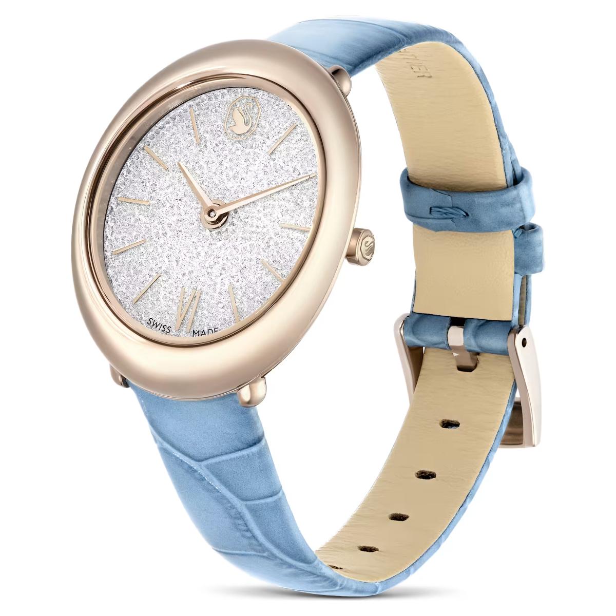 Watch with blue strap and rose gold case on a white background