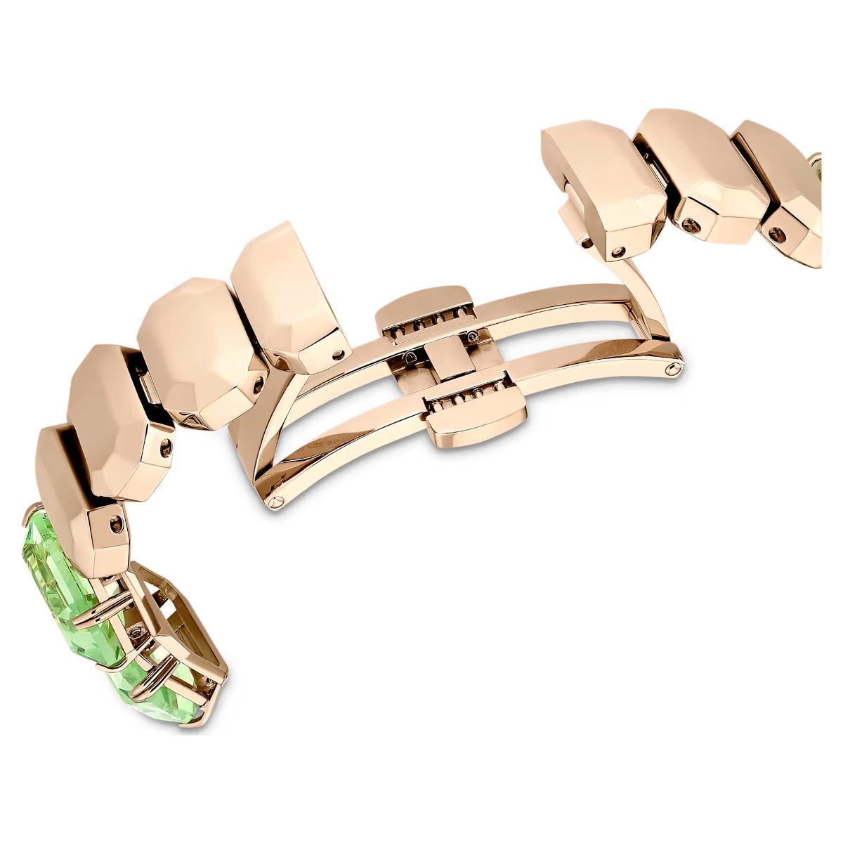 Rose gold bracelet with green gemstones on a white background