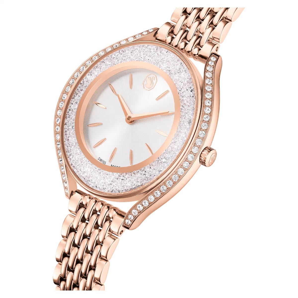 Rose gold watch with a decorative face on a white background