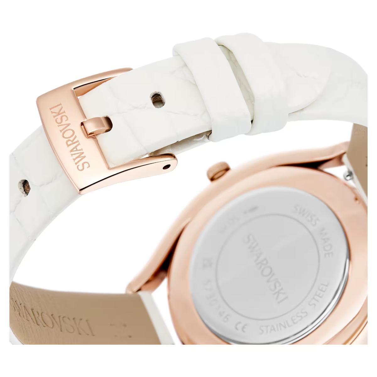 Watch with white strap and rose gold buckle, featuring Swarovski branding.