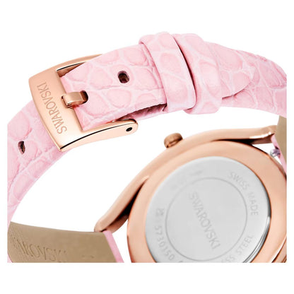 Close-up of a Swarovski watch with pink strap and rose gold case.