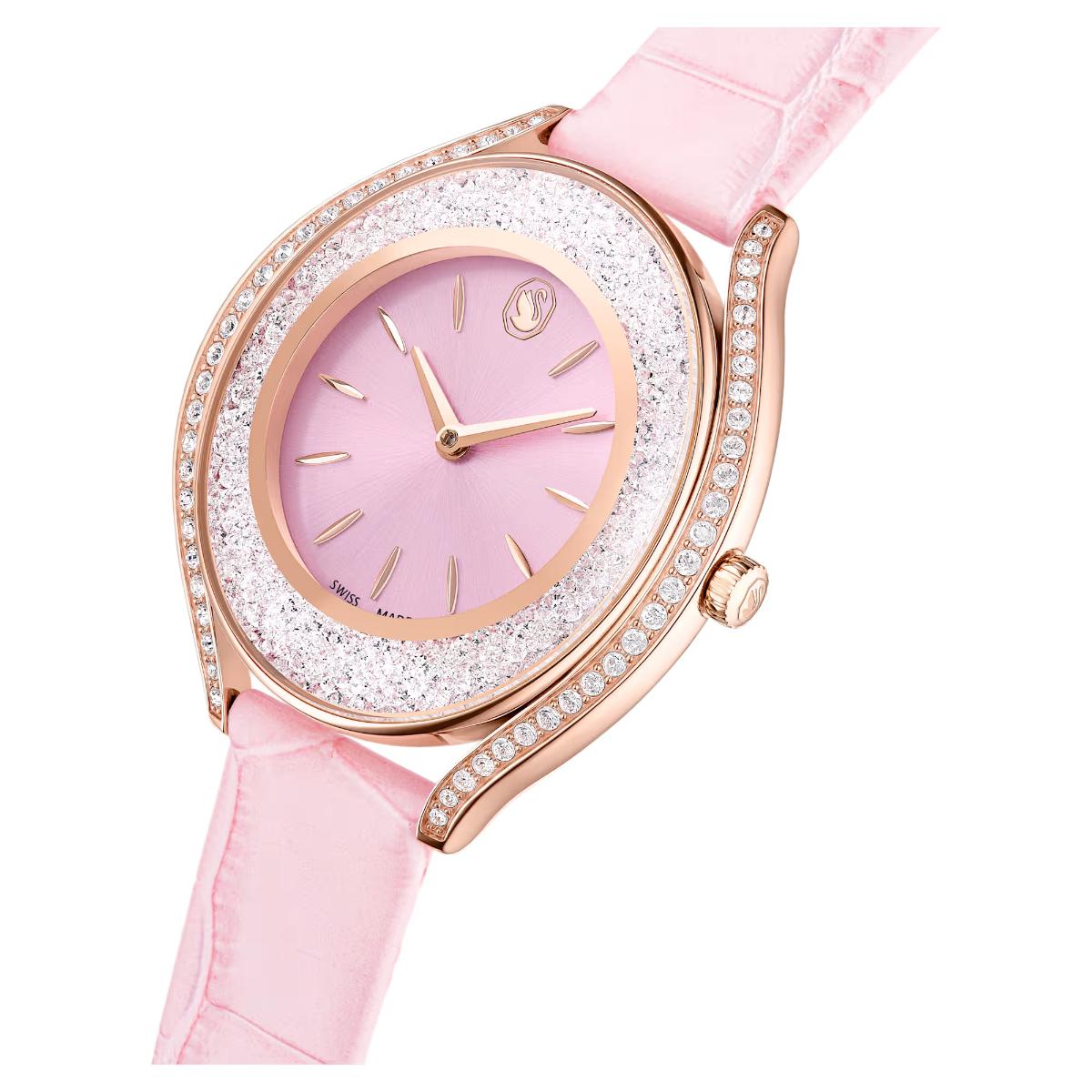 Pink watch with rose gold accents on a white background