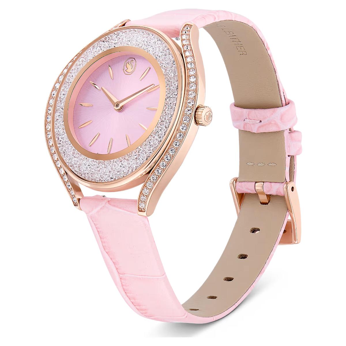 Pink watch with rose gold accents on a white background