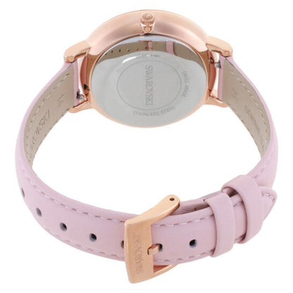 Watch with pink strap and rose gold case on a white background