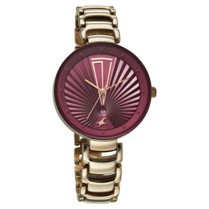 Gold watch with a maroon face on a white background