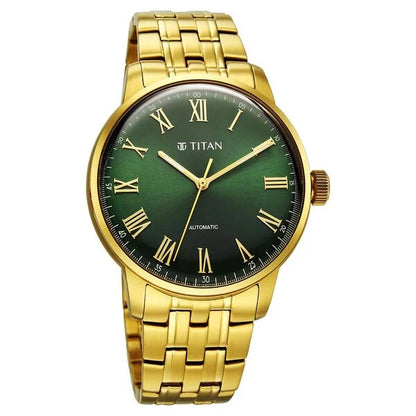 Gold wristwatch with a green dial and Roman numerals on a white background