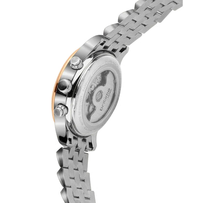 Close-up of a silver watch with a detailed face on a white background