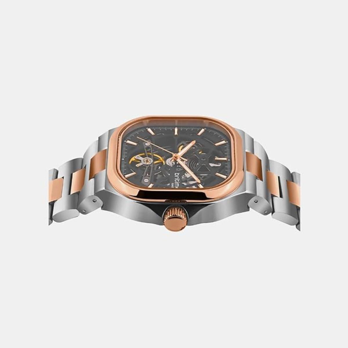 Luxury watch with silver and rose gold band on a light gray background