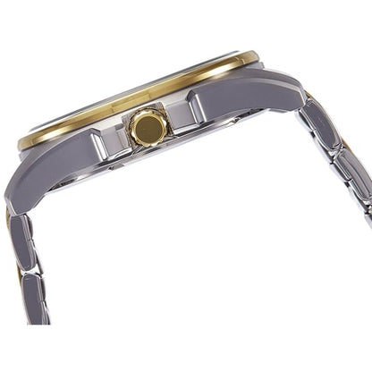 Close-up of a watch with a gold bezel and silver band on a white background