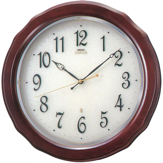 Wall clock with wooden frame and white face displaying time.