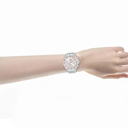Wrist wearing a silver watch with a pink face on a white background