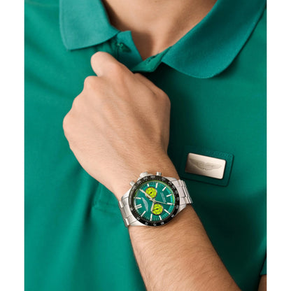 Person wearing a green shirt with a watch on their wrist