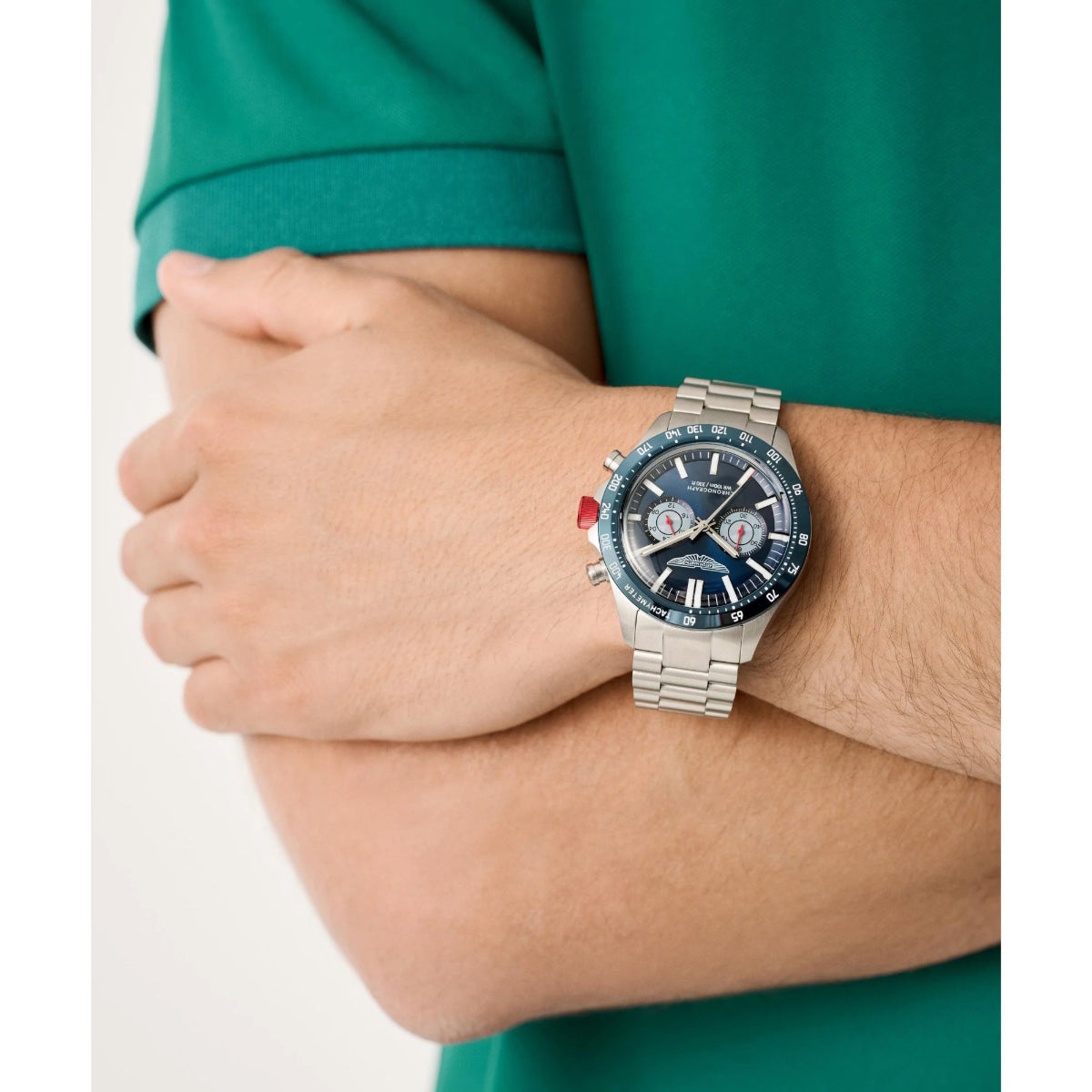 Silver watch on a wrist with a green shirt