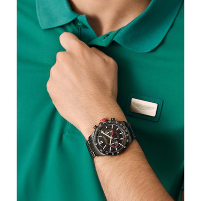 Person wearing a green polo shirt with a watch on their wrist