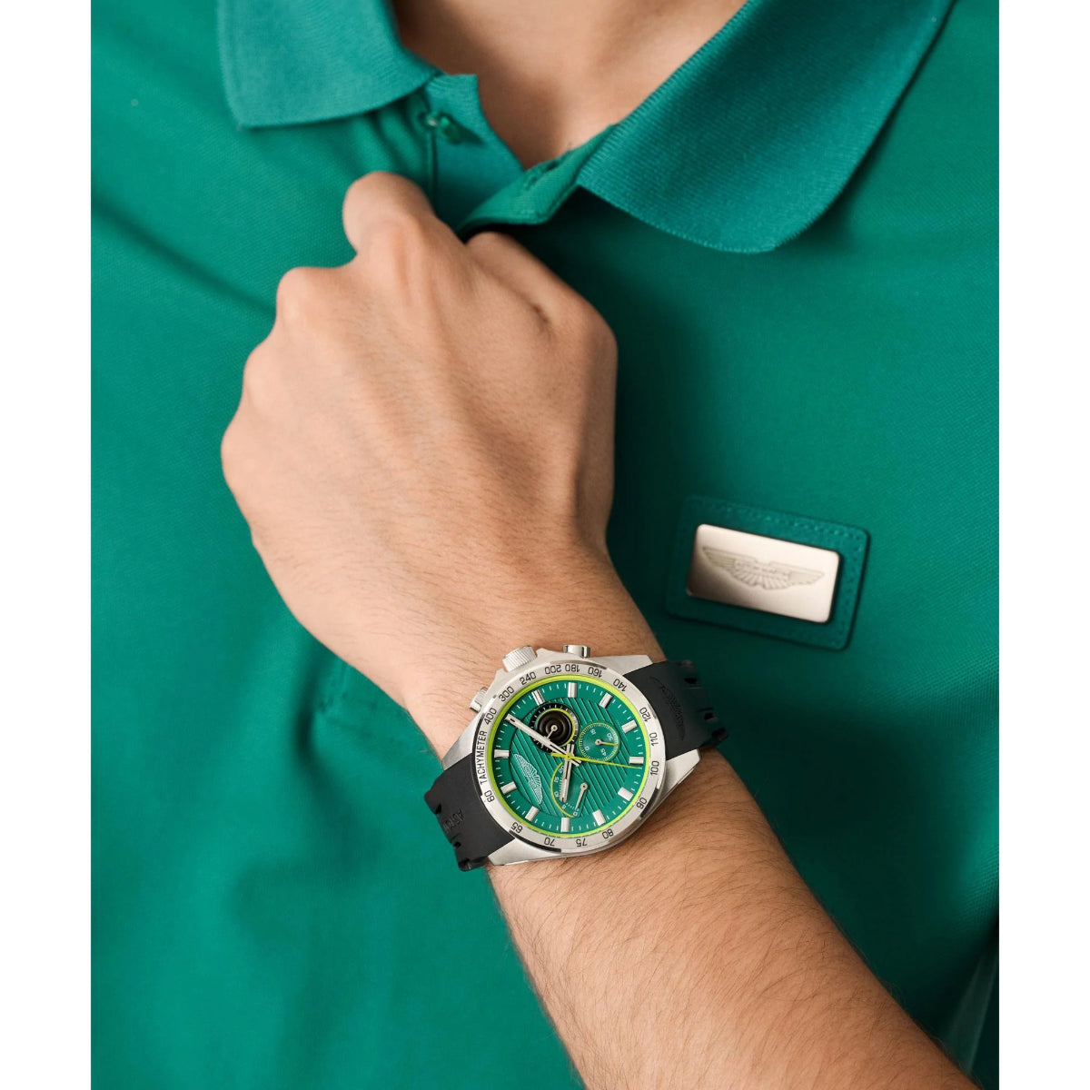 Person wearing a green watch with a matching green shirt