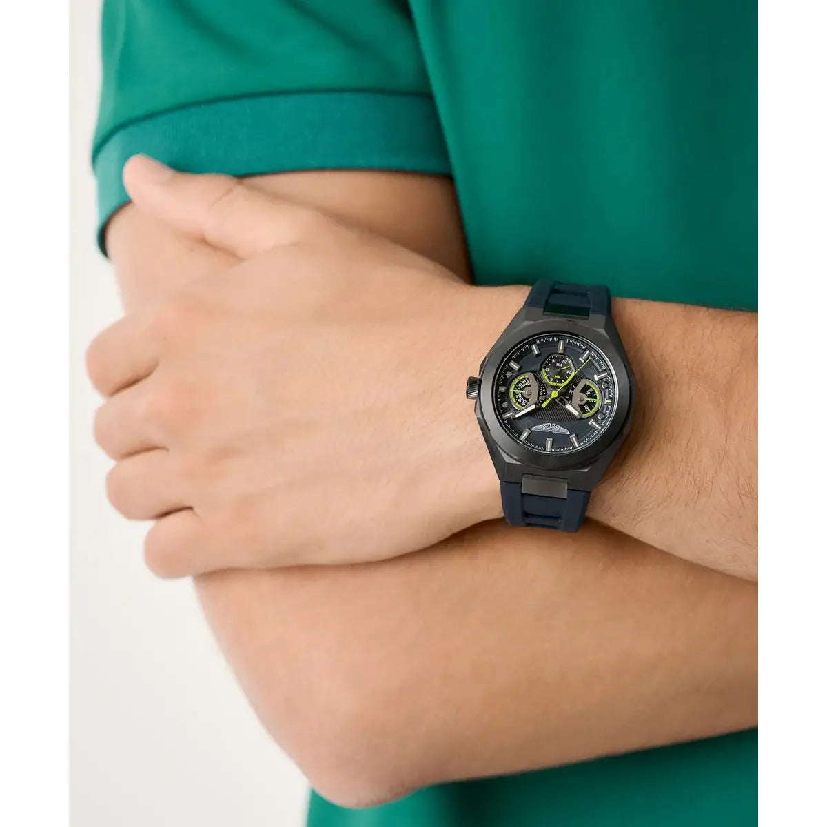 Person wearing a black wristwatch with a green shirt