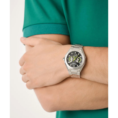 Person wearing a silver watch on a plain background