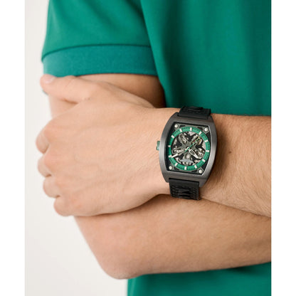Person wearing a black wristwatch with green accents on a white background