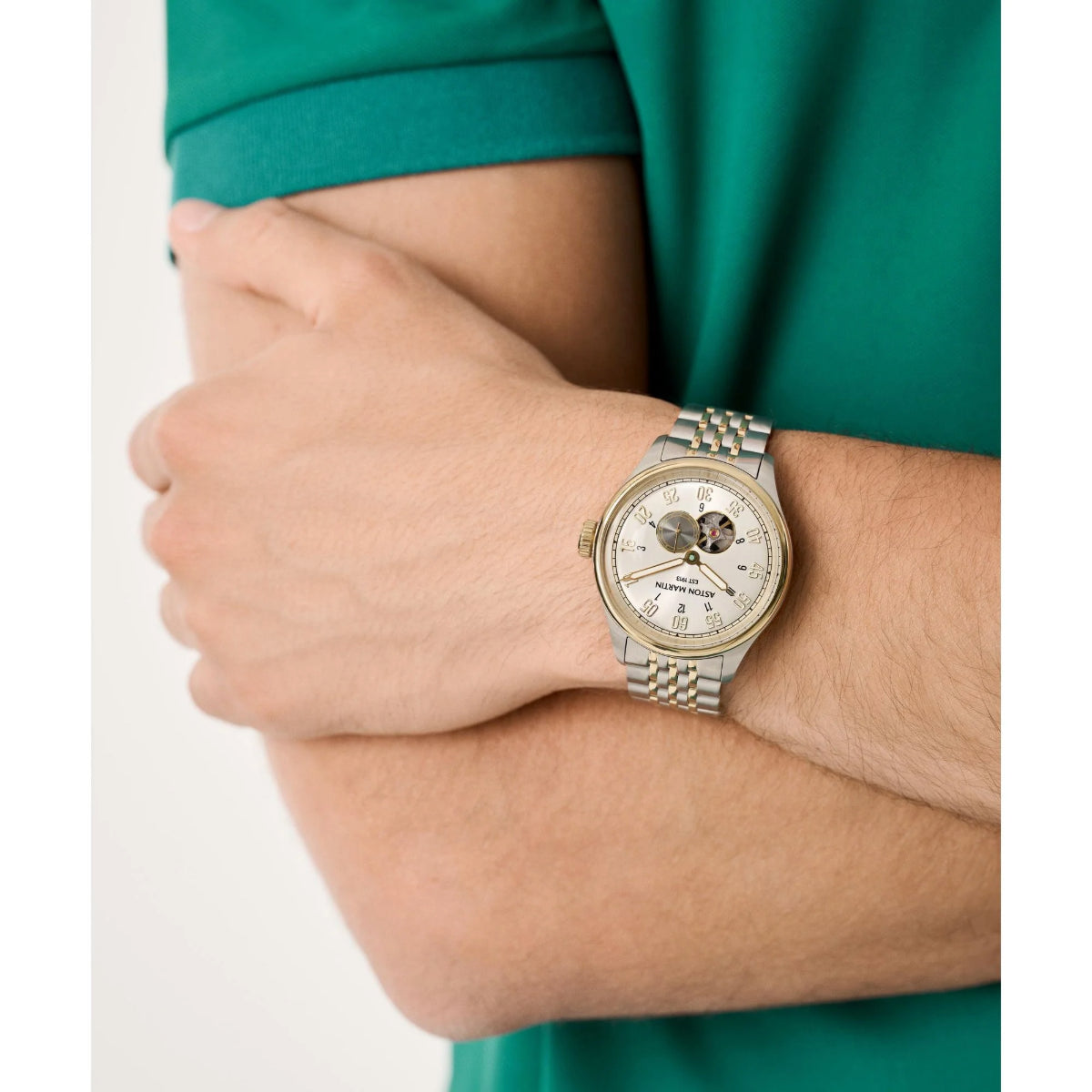 Silver watch on a wrist with a green shirt