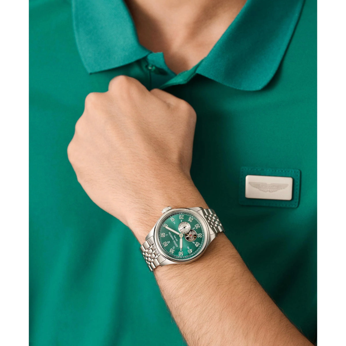 Person wearing a green watch with a matching green shirt