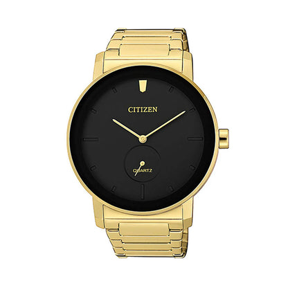 Gold watch with black face on a white background