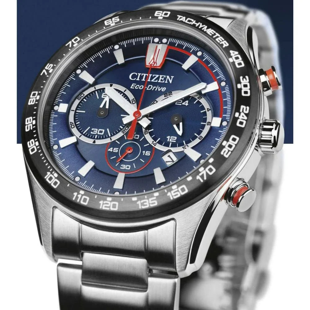 Citizen watch with blue dial and silver metal strap on a dark background