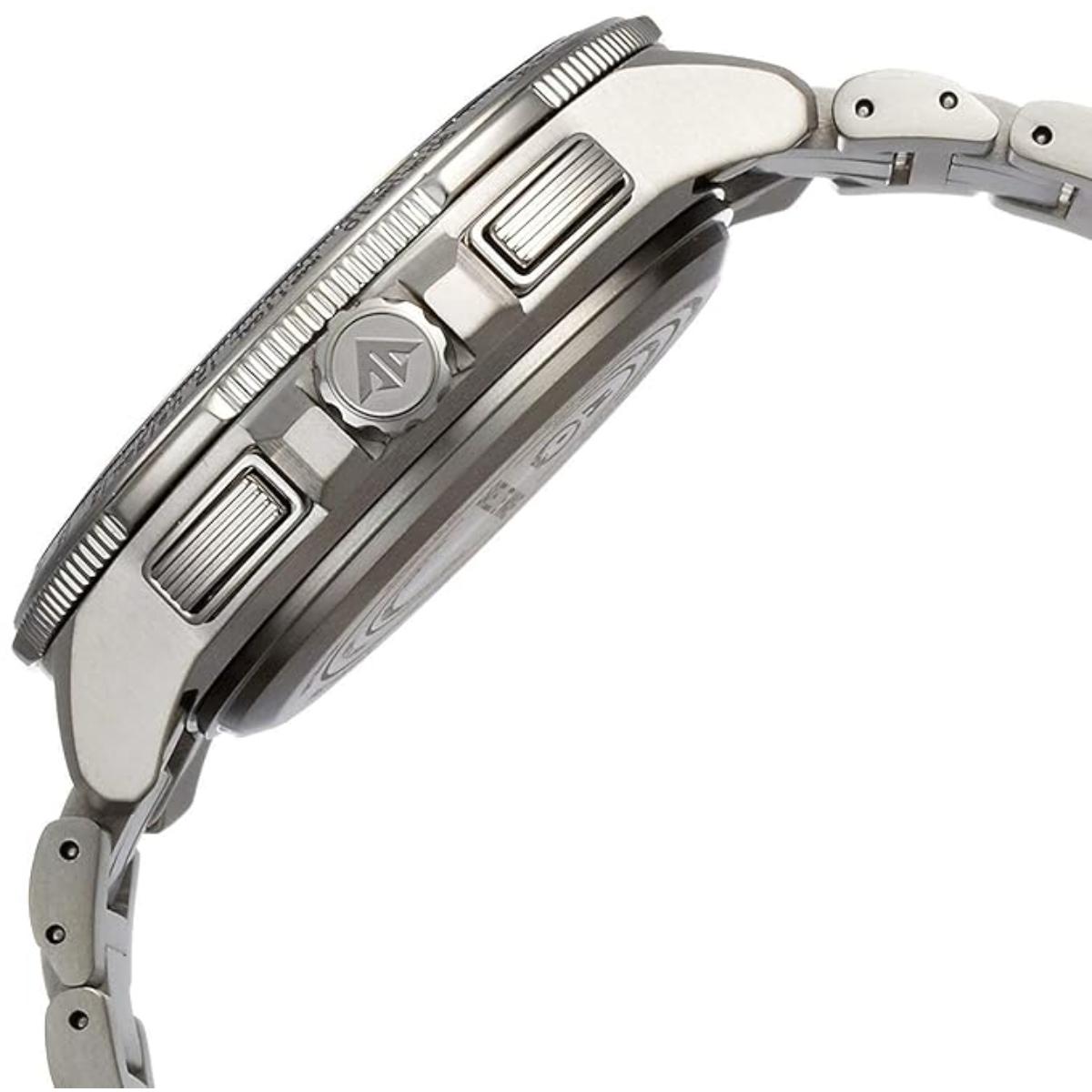 Close-up of a silver watch with detailed design on a white background