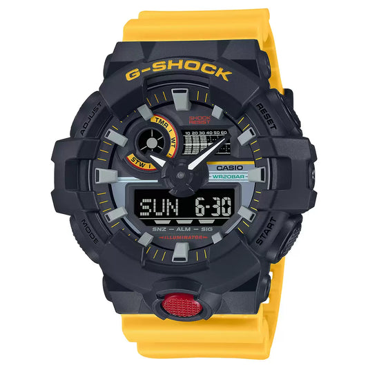 A Casio G-SHOCK GA-700MT-1A9DR watch with a black and yellow color scheme, featuring an analog-digital display, a digital dial, and a prominent front button.