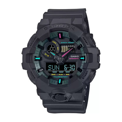 A Casio G-SHOCK GA-700MF-1ADR analog-digital men's watch with a black band and bezel, featuring vibrant fluorescent color accents in blue, pink, and yellow on the dial.