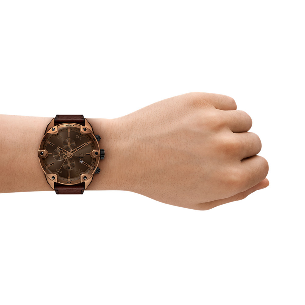 Hand wearing a bronze wristwatch on a white background