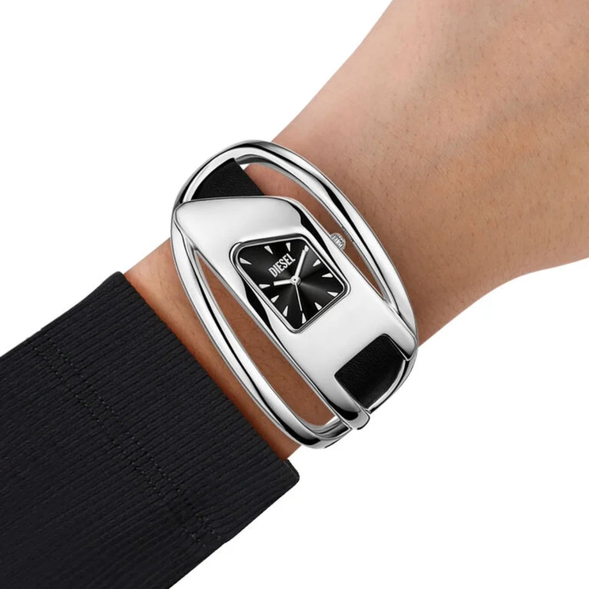 Silver bracelet with a black watch face on a wrist against a white background
