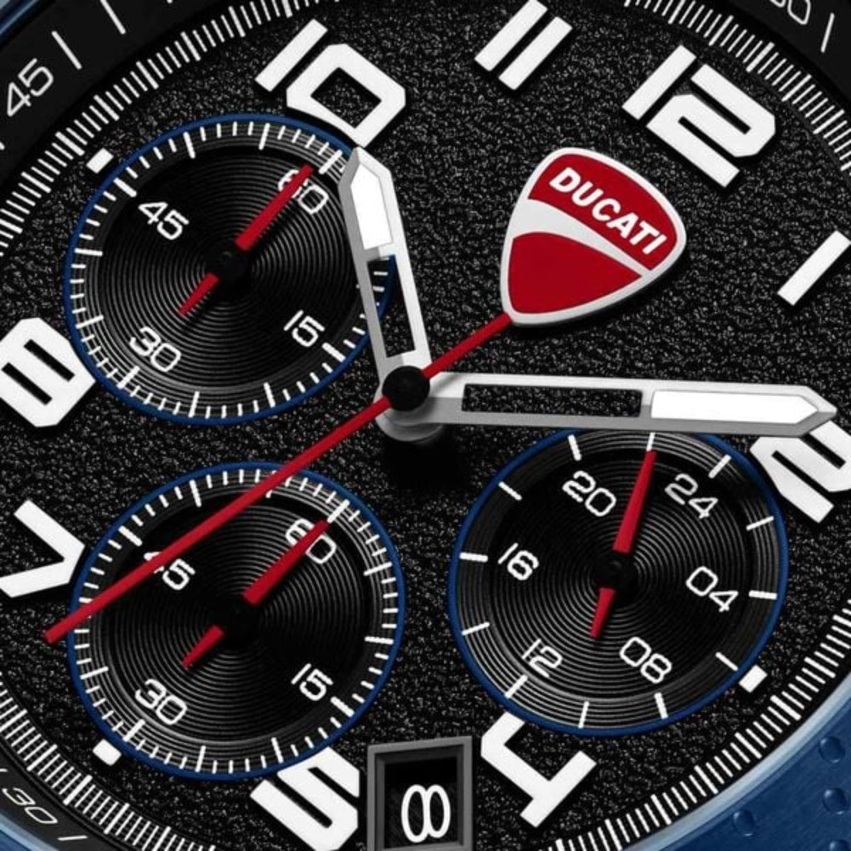 Ducati branded watch face with three sub-dials on a black textured background