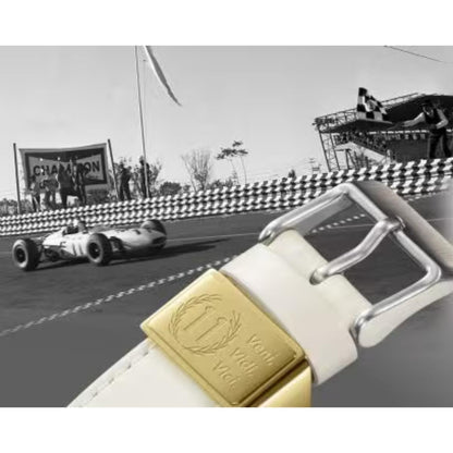 Vintage racing car on a track with a white belt featuring a gold buckle overlay.