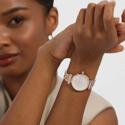 Woman wearing a rose gold watch with a white background