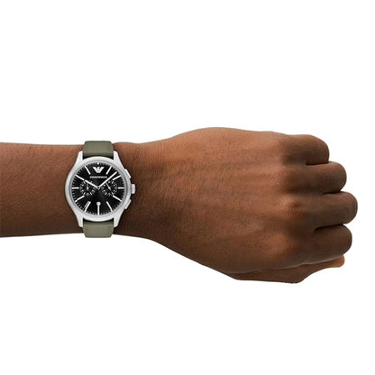 Hand wearing a watch with a white strap on a white background