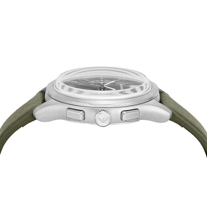 Close-up of a watch with a silver case and green strap on a white background