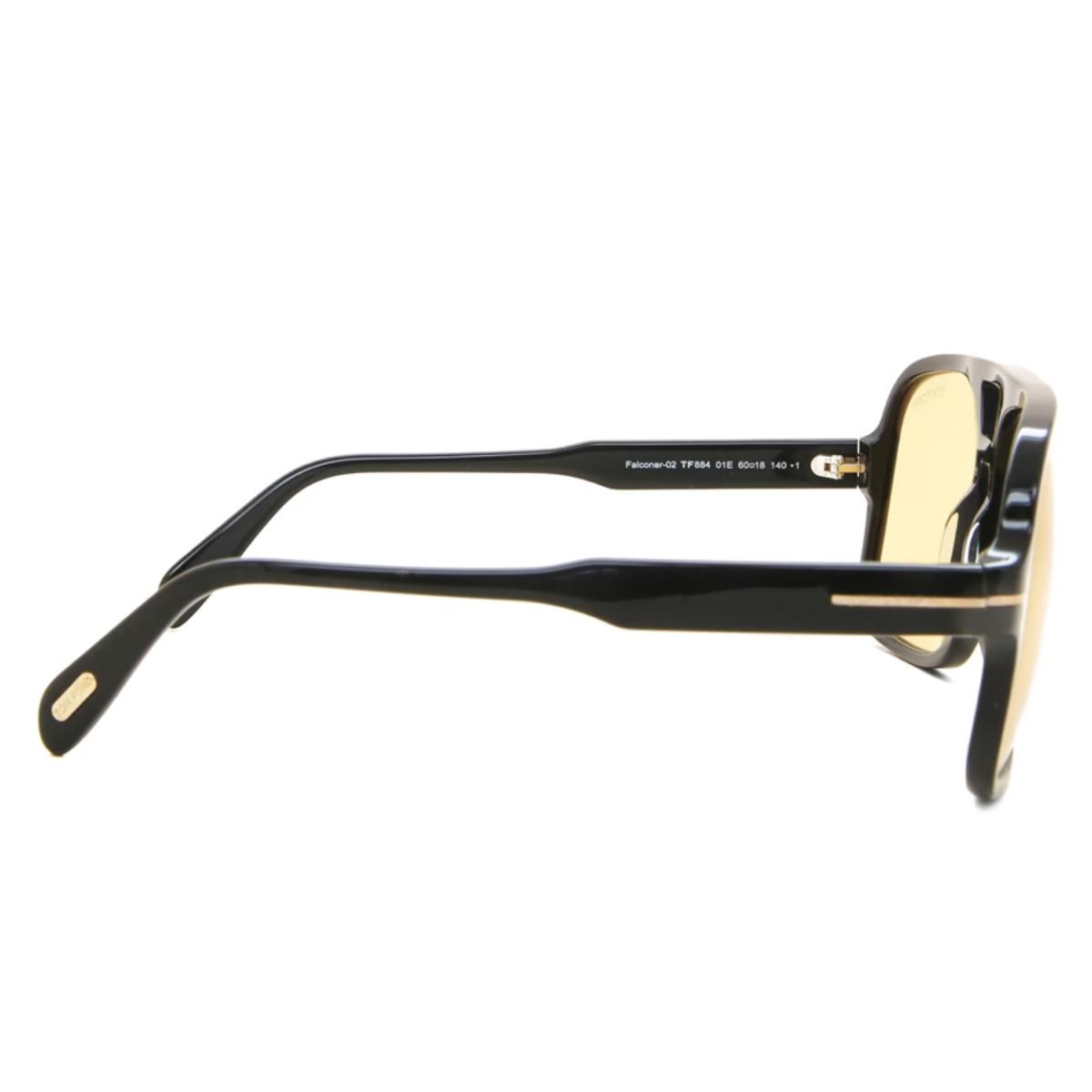 Black sunglasses with gold accents on a white background