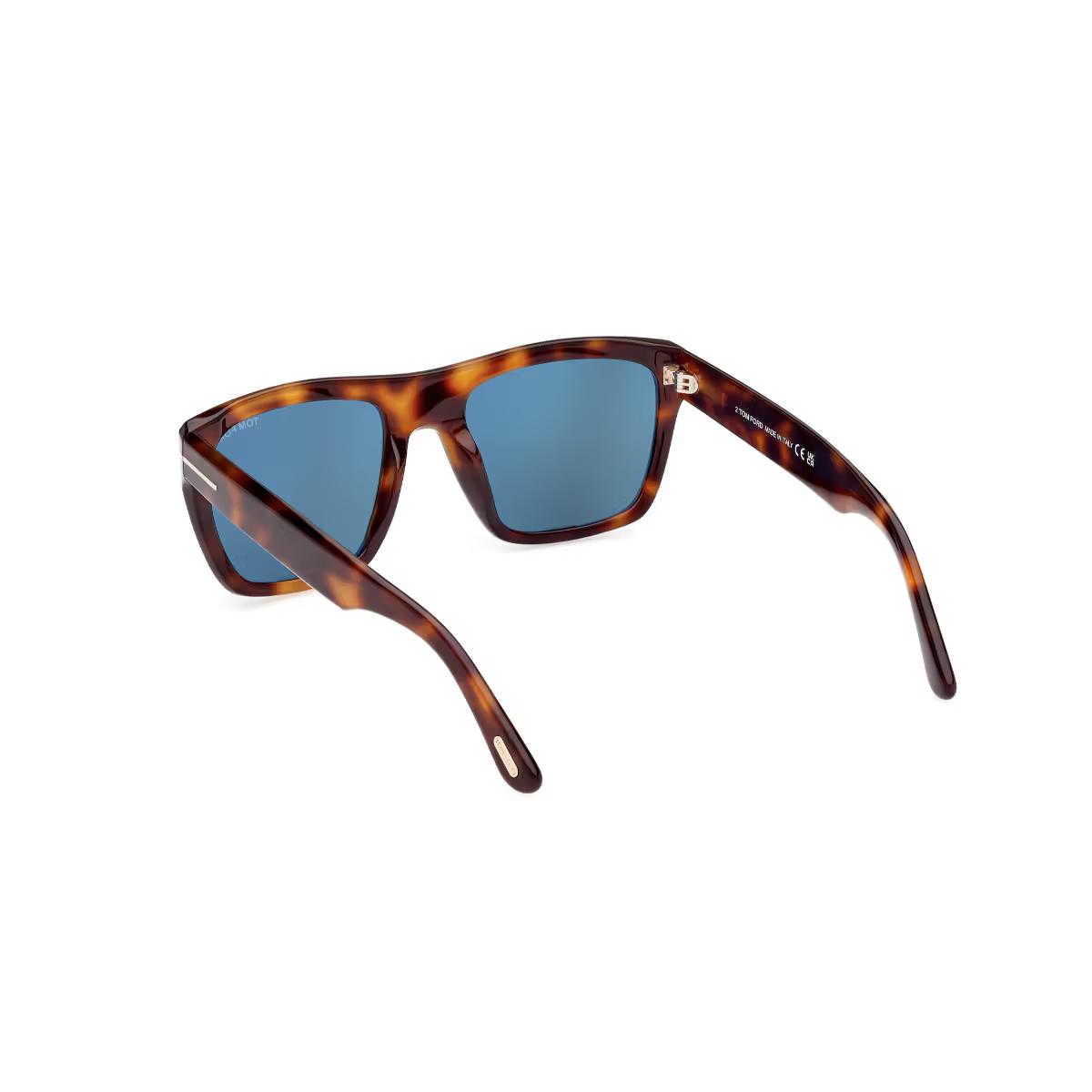 Sunglasses with tortoiseshell frame and blue lenses on a white background