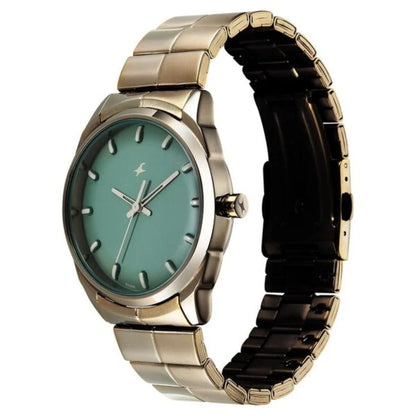 Wristwatch with green face and gold metal band on a white background