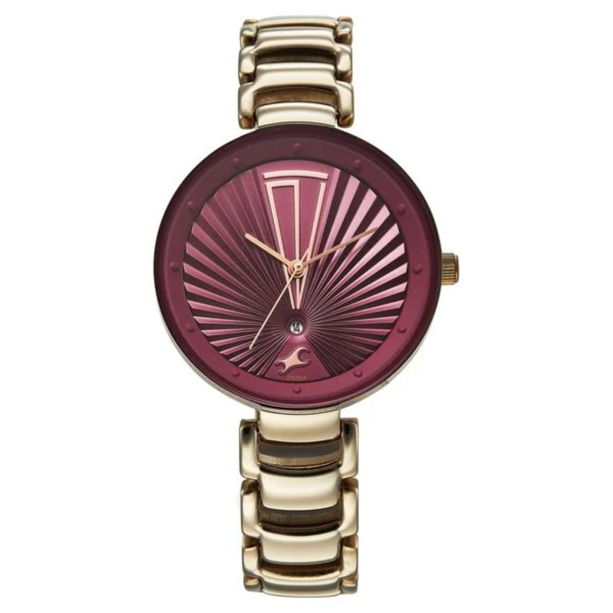 Gold watch with a reddish-purple face on a white background
