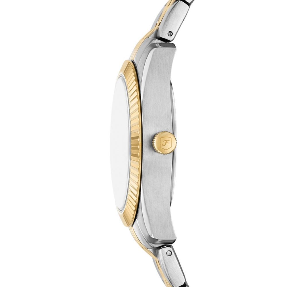 Close-up of a two-tone watch with gold and silver accents on a white background